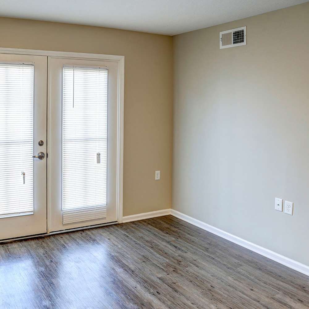 Spacious living room with wood-style flooring at Pebblecreek Crossing in Richmond, Kentucky