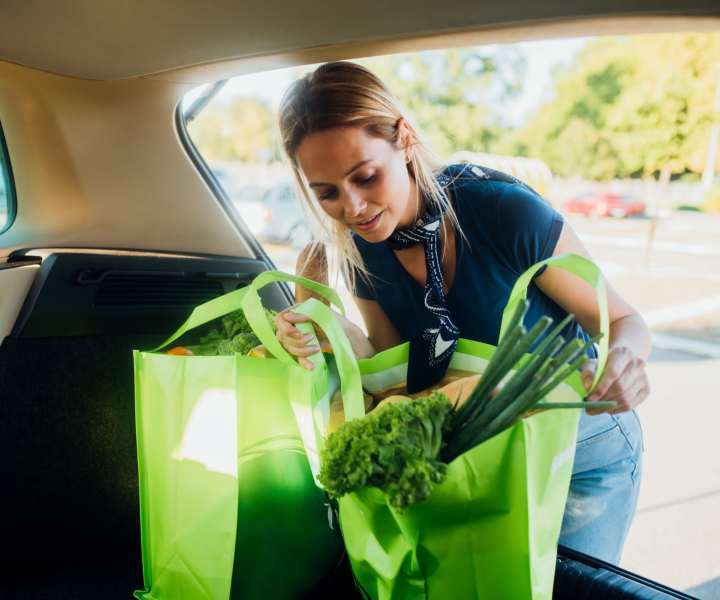 Resident woman putting shopping bags in her car near Addison Grove in Avon Park, Florida