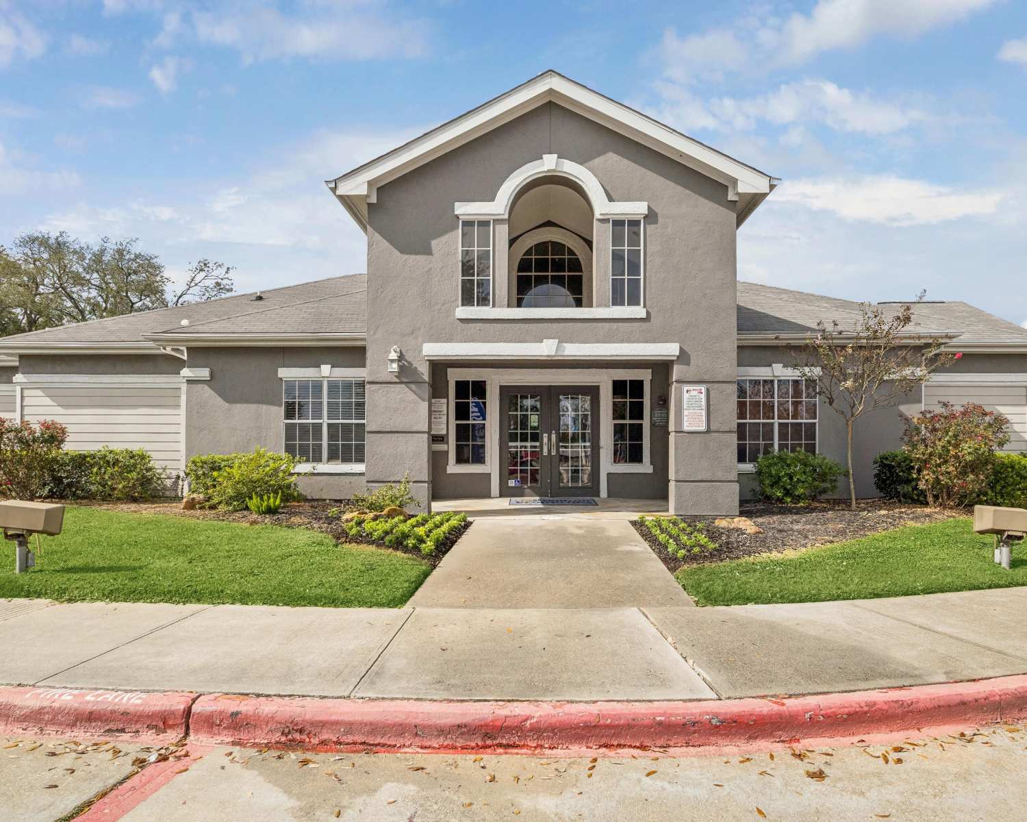 Stylish entrance to a modern residential community center at Villas At Alexander Bay in Baytown, Texas 