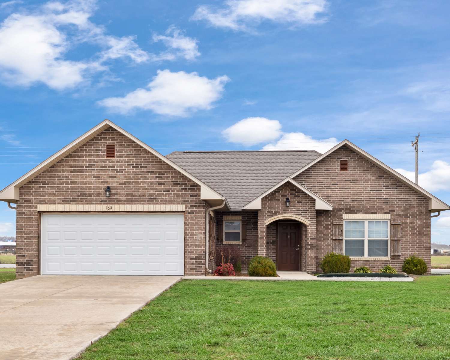 Exterior view of apartment with garage at Oaklawn II in Rogersville, Missouri