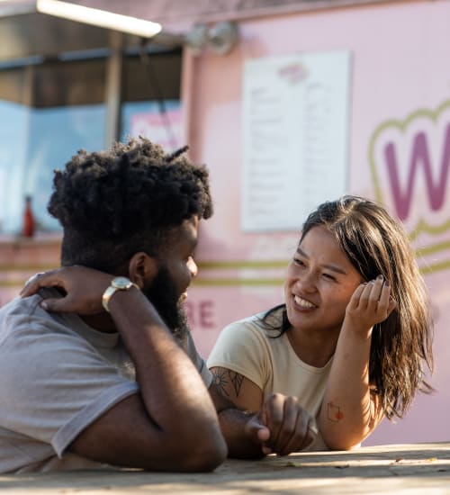 Resident couple chatting near a downtown food truck while waiting for their order near 44 South in Austin, Texas