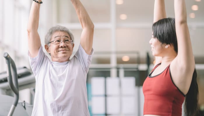 Resident working with a trainer at The Springs at Lake Oswego in Lake Oswego, Oregon
