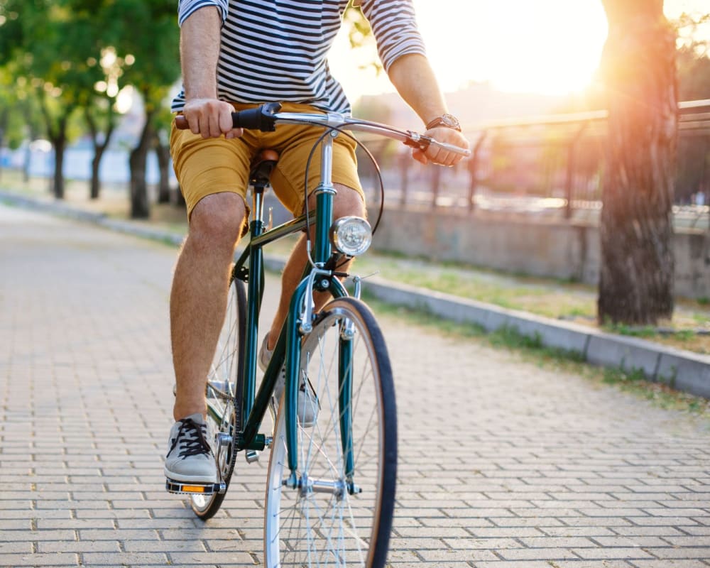 Resident rides his bike around the neighborhood at The Ralston at Belmont Hills in Belmont, California