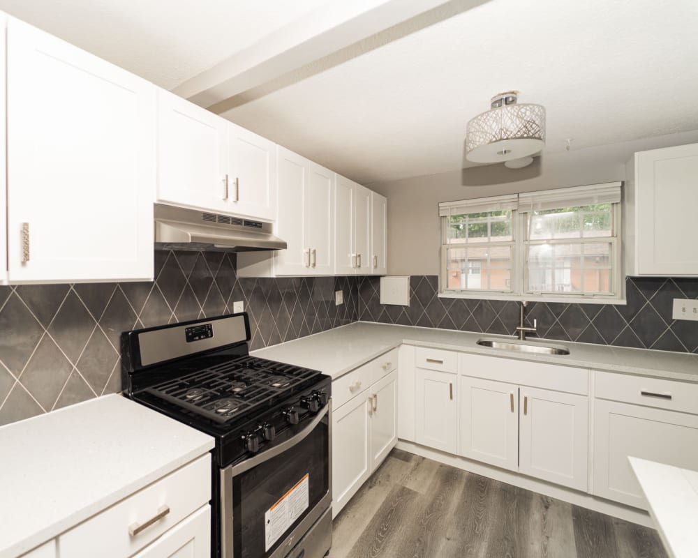 Modern kitchen and wood-style floors at Bayshore Apartments in East Haven, Connecticut