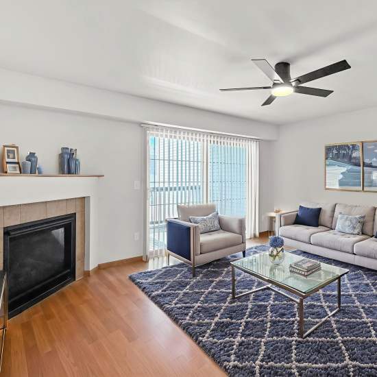 Living room with wooden flooring and fireplace Prairie Bend in Cedar Rapids, Iowa
