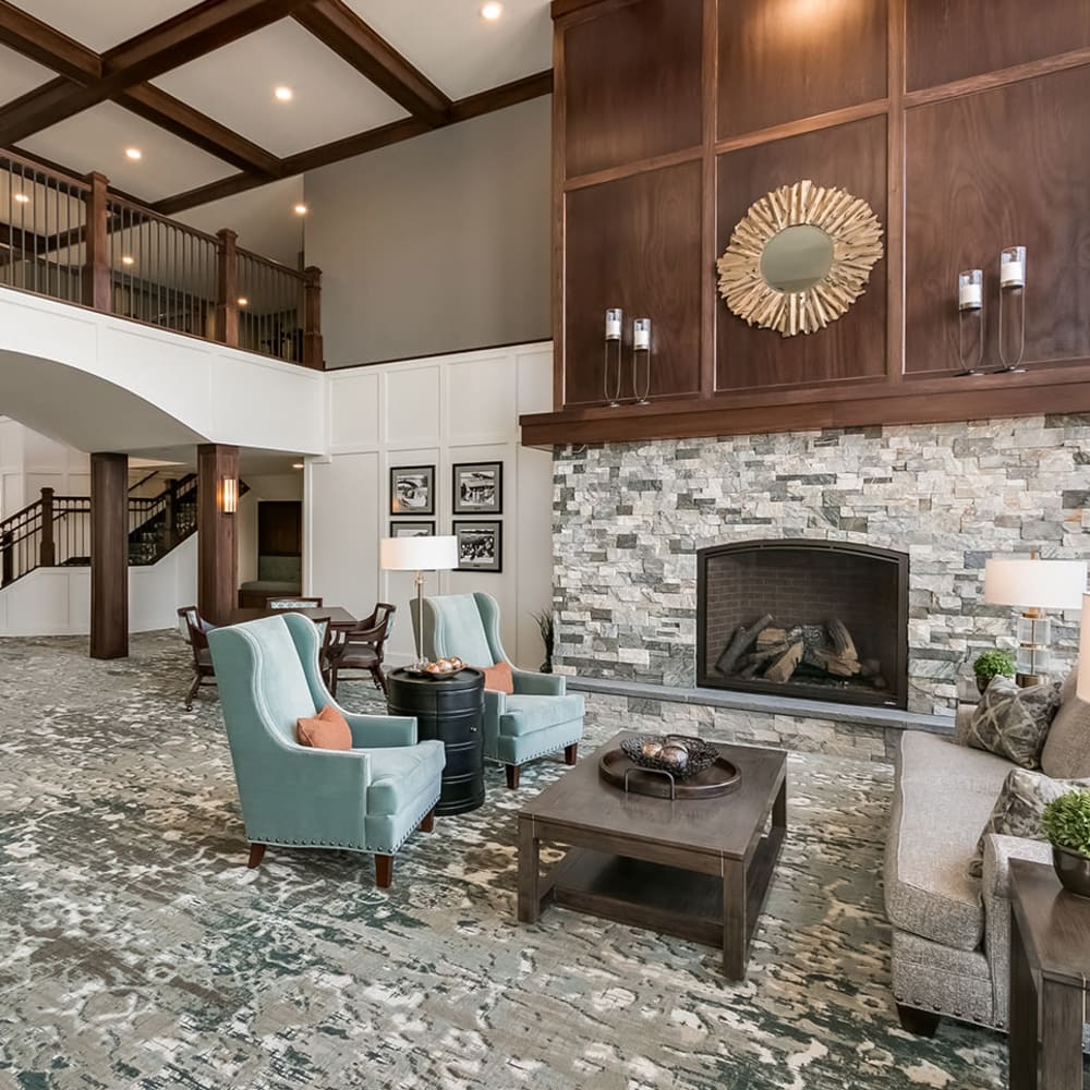 Lobby with a fireplace at Applewood Pointe of Champlin at Mississippi Crossings in Champlin, Minnesota. 