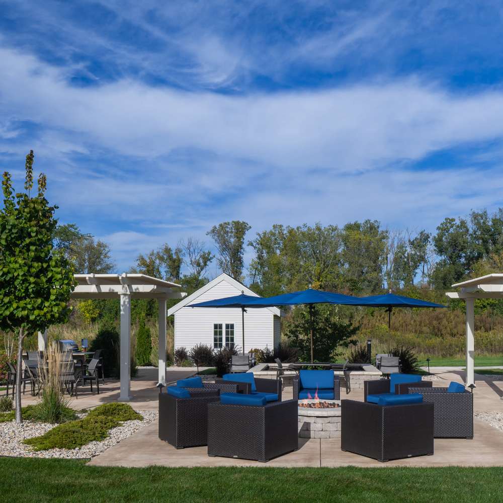 Charming outdoor lounge area with stylish seating and a cozy fire pit at Lake Pointe Apartments in Madison, Wisconsin.