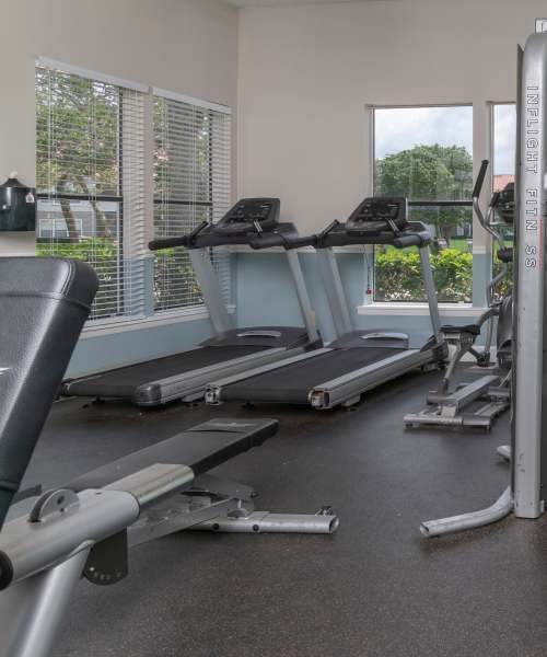 Resident exercising in fitness center at Isles at East Millenia in Orlando, Florida