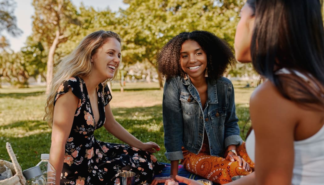 Friends enjoying a picnic at a local park in Lubbock, Texas near Cottages at Abbey Glen Apartments
