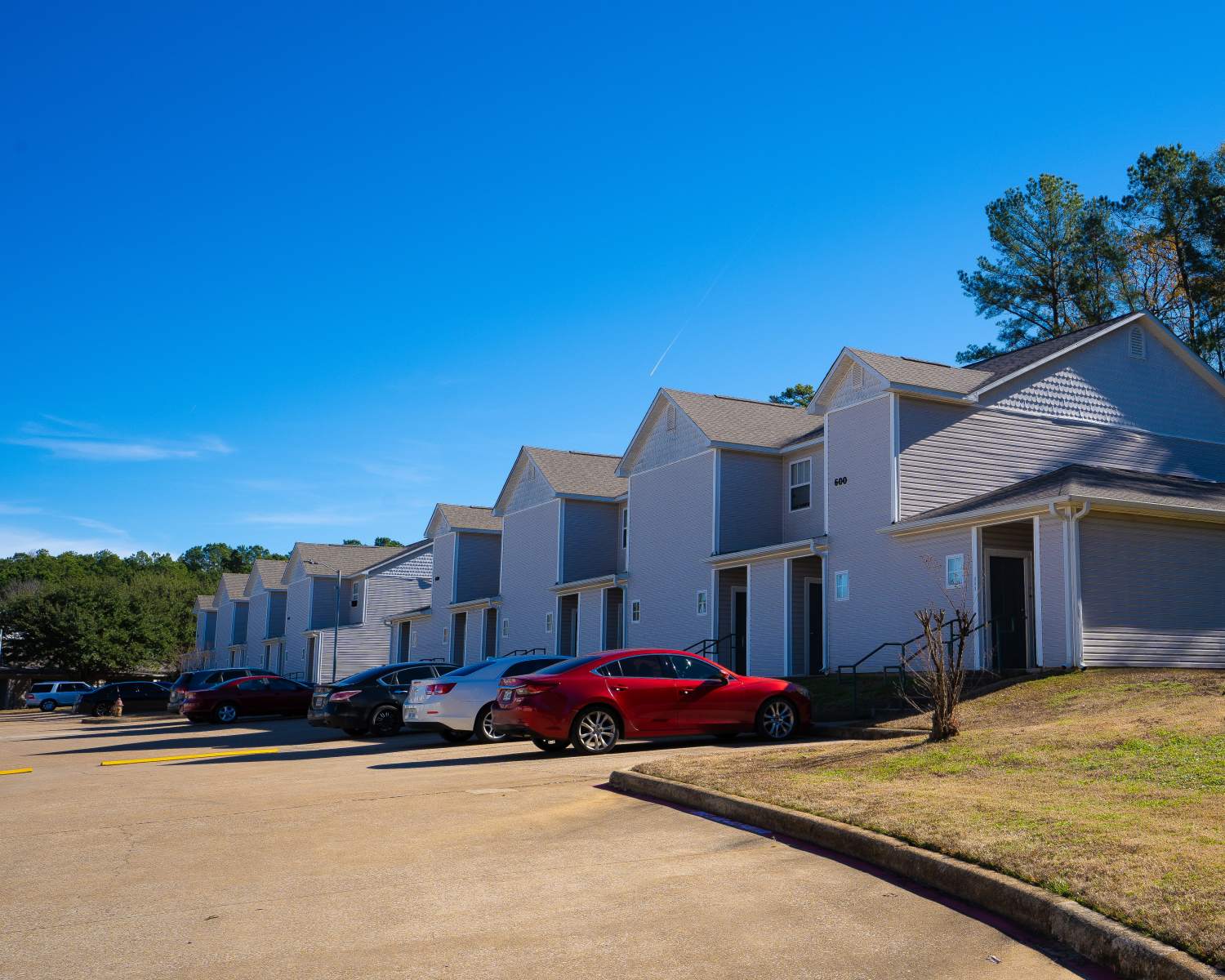 Exterior view of the apartment building with car parking space at Ryan's Crossing in Marshall, Texas