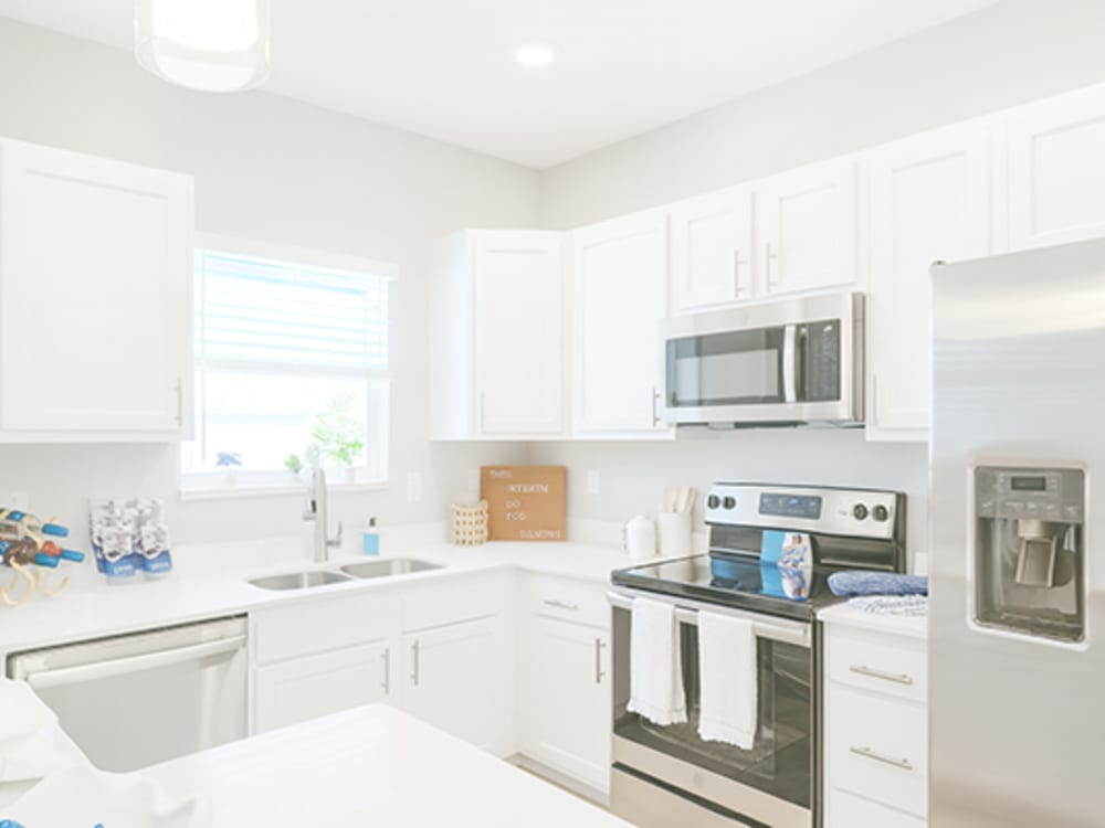 Modern kitchen with stainless-steel appliances at Viva At Palm Coast in Palm Coast, Florida