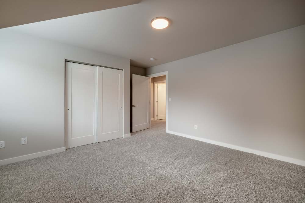 Unfurnished bedroom with carpet flooring at 14th Street Townhomes in East Wenatchee, Washington