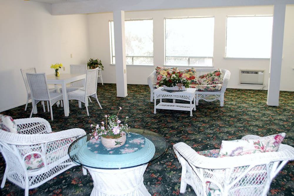 Dining room area with large windows and lots of natural light at Leisure Manor Apartments in Sacramento, California