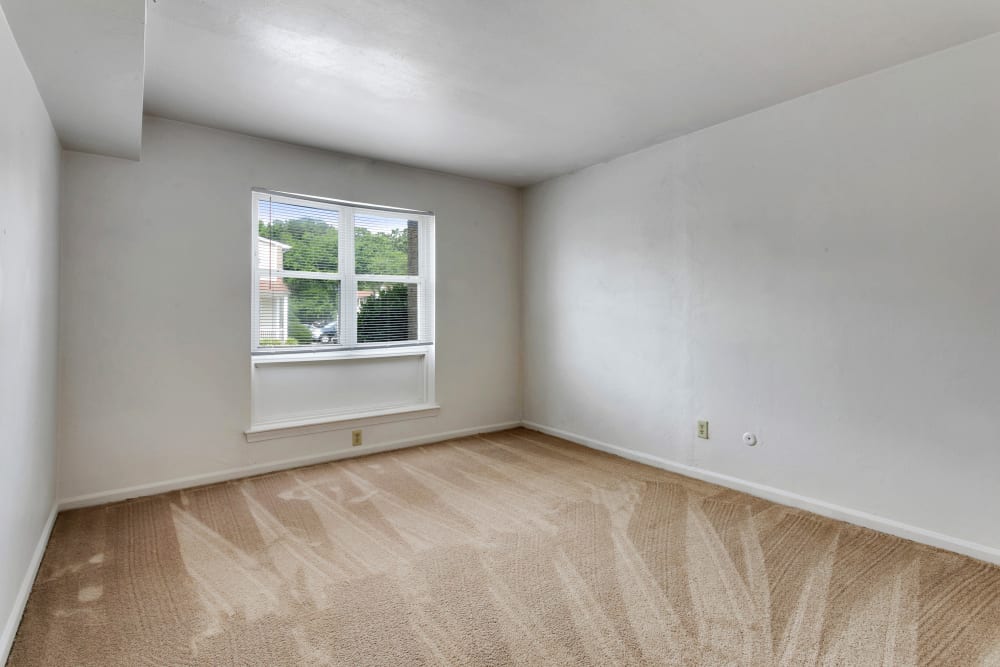 Empty bedroom with white walls and a window at Admiral's Way in Norfolk, Virginia