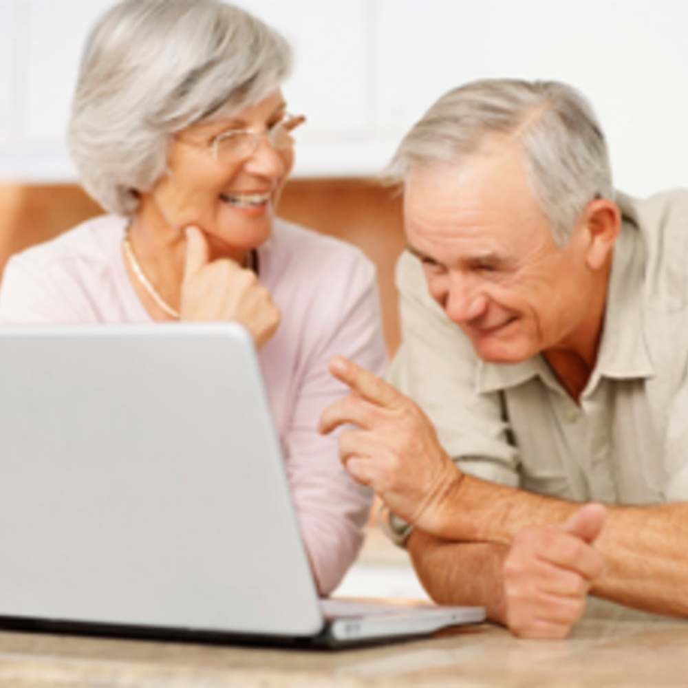 Senior couple watching laptop at Parkview Terrace in Los Angeles,California