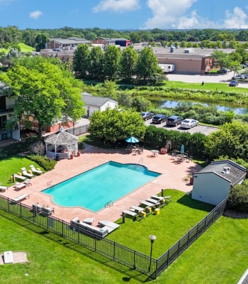 Outdoor swimming pool and Gazebo with surrounded by green landscape at Equinox Apartments in Saint Anthony, Minnesota