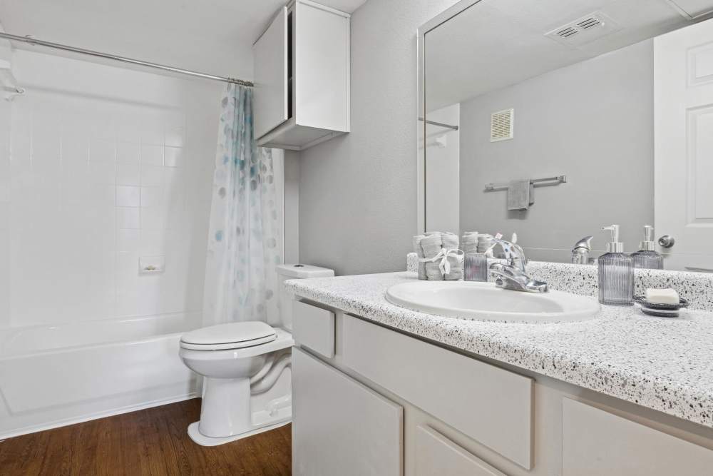 Bathroom of apartment with bathtub and storage vanity at Lansbourough in Houston, Texas