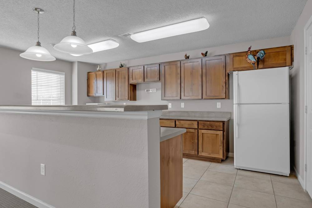 Community kitchen with white appliances at River Ridge in Sand Springs, Oklahoma