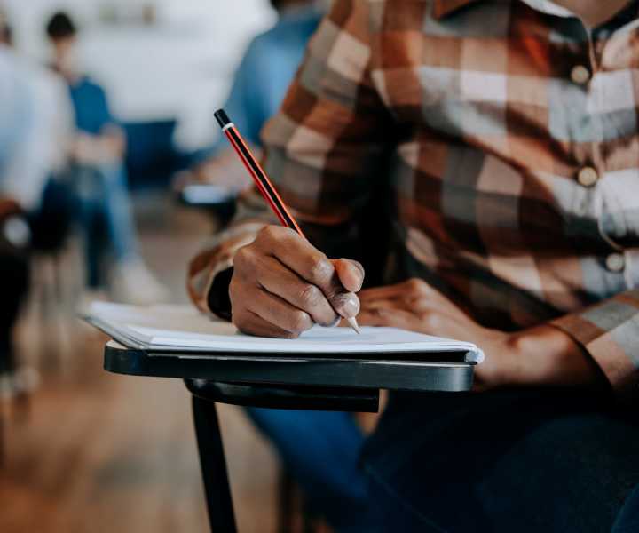 Student writing near The Haven in Webster, Texas