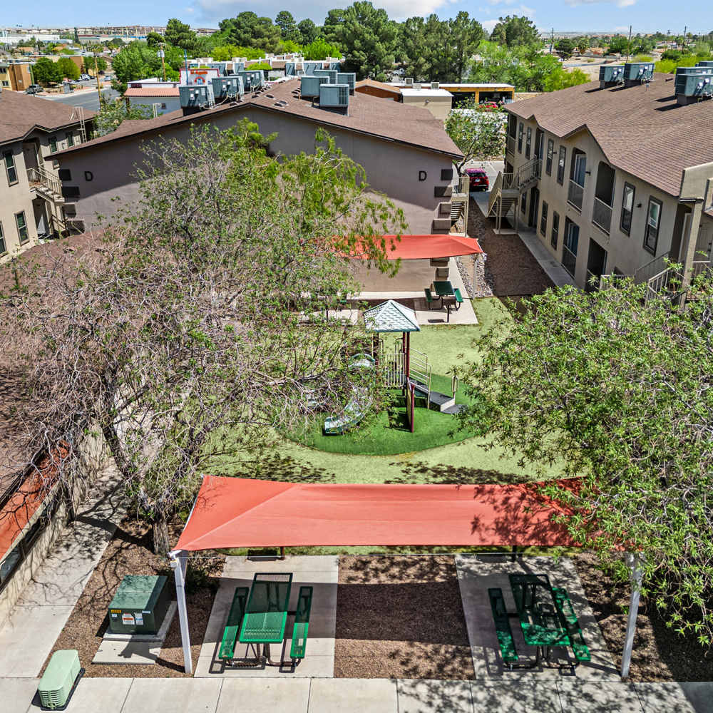 Courtyard with lawn and playground at La Jolla Place in El Paso, Texas