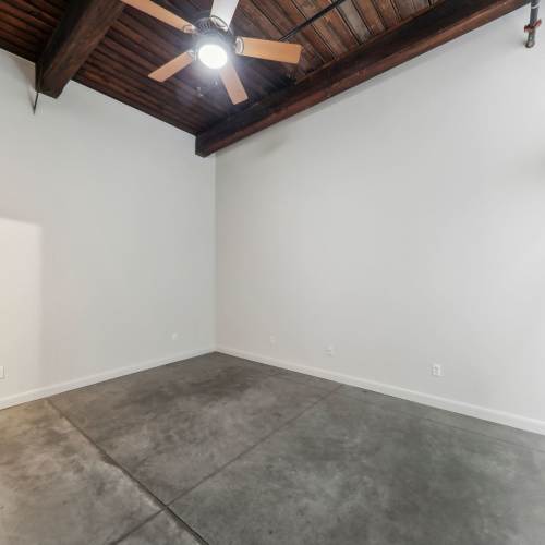 Unfurnished bedroom with high ceiling and ceiling fan at Stadium Loft Apartments in Saint Louis, Missouri