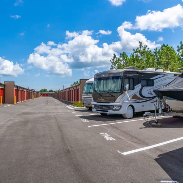 RVs and a boat parked safely at StorQuest Self Storage in Acampo, California