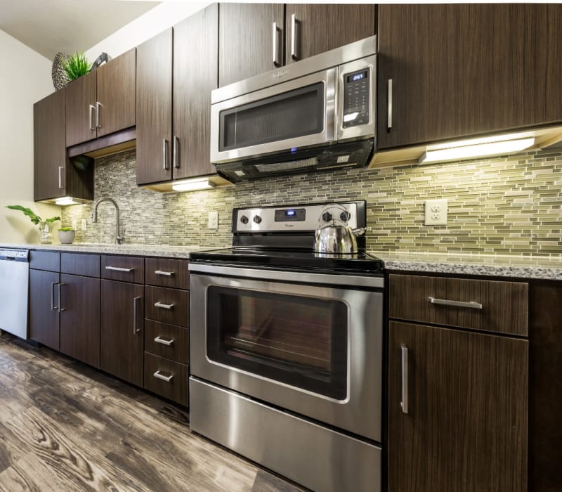 Spacious kitchen with kitchen island and counter stools at Marq Uptown in Austin, Texas