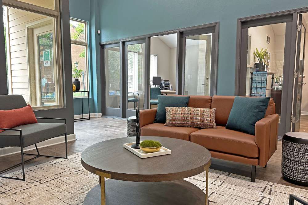 Large clubhouse with leather sofa at West End Terrace Apartments in St. Louis, Missouri