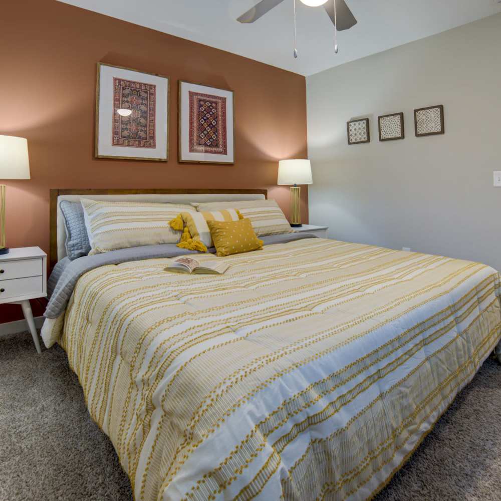 Bedroom with cozy bed and side lamp at Avonlea Westside in Atlanta, Georgia