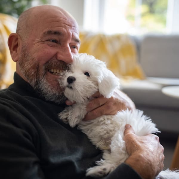 A resident holds his puppy at Attain Downtown, Norfolk, Virginia