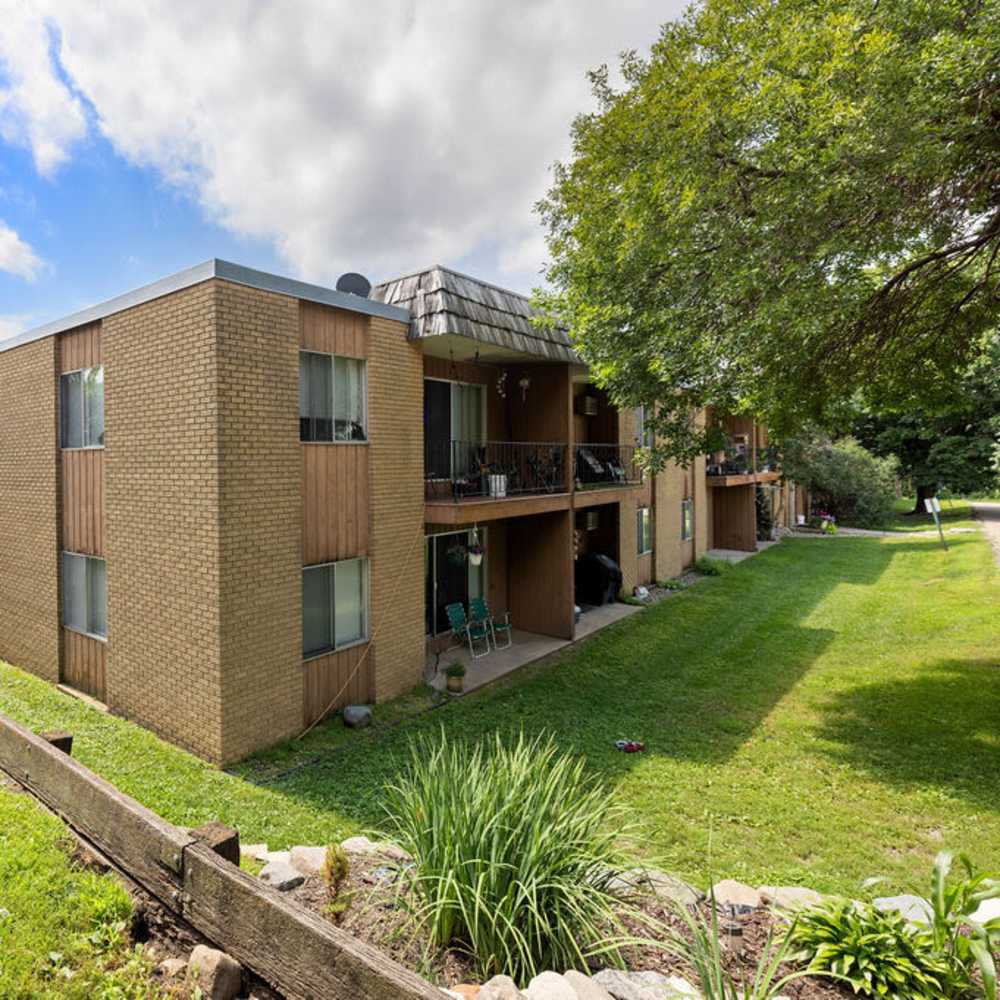 Apartment back yard lawn with trees view at Solace on Lake Minnetonka in Spring Park, Minnesota