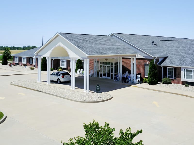 Side view of front entrance of senior living facility on sunny day at Garden Place Waterloo in Waterloo, Illinois. 