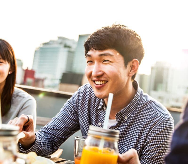 Friends enjoying beverages at Arthaus Apartments in Allston, Massachusetts