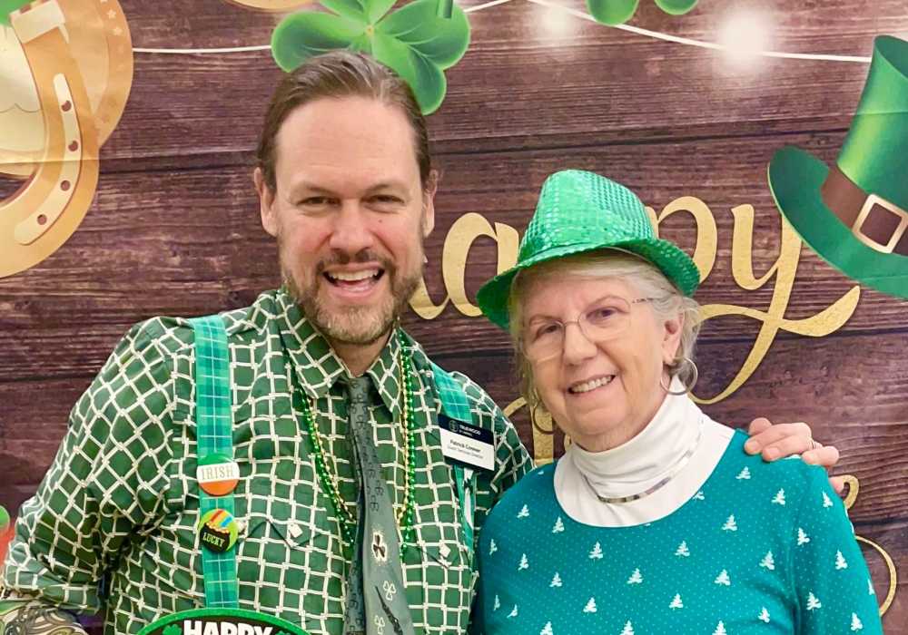 Resident and caretaker celebrating St. Patrick's Day at Truewood by Merrill, First Hill in Seattle, Washington