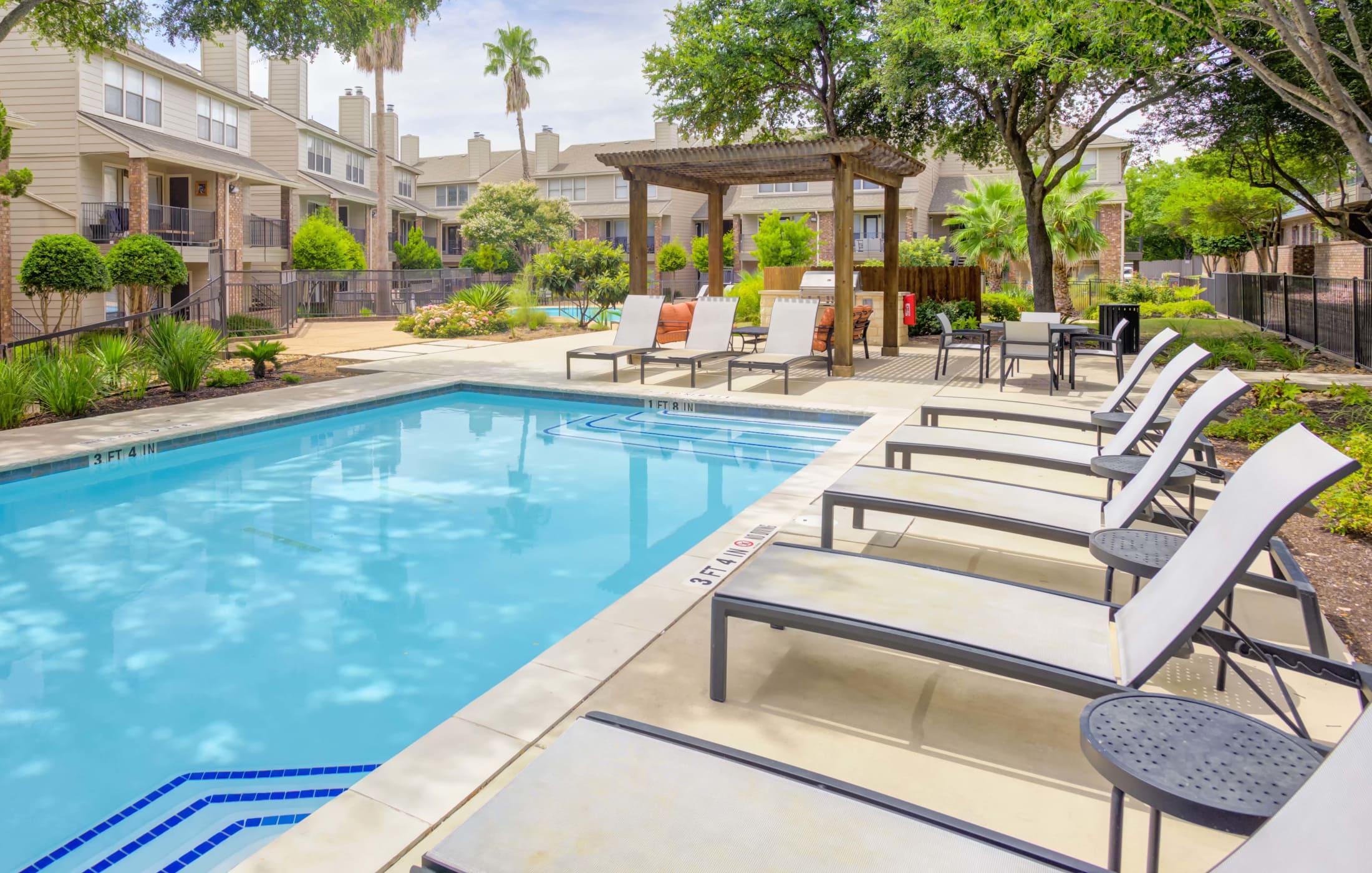Refreshing swimming pool at Enclave at Water's Edge Apartments.