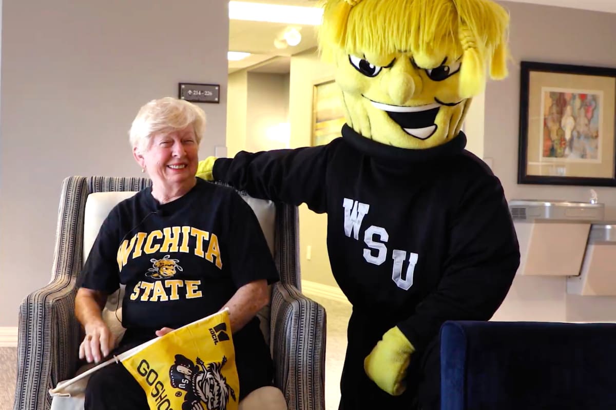 Resident with a mascott at Oxford Villa Active Senior Apartments in Wichita, Kansas