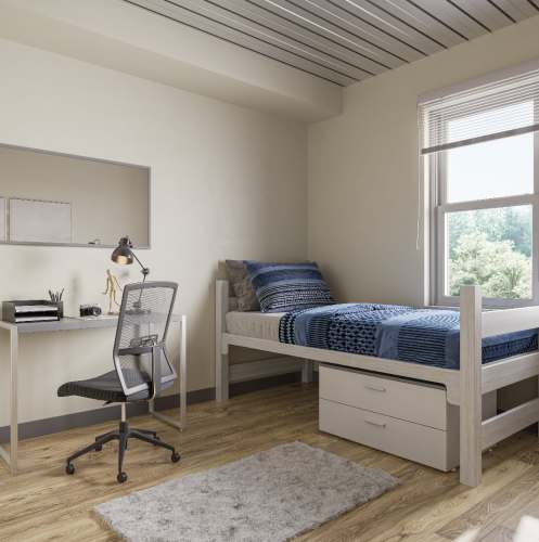 Bedroom with bed and study table at Polly O'Meara Doyle Hall in Santa Rosa, California