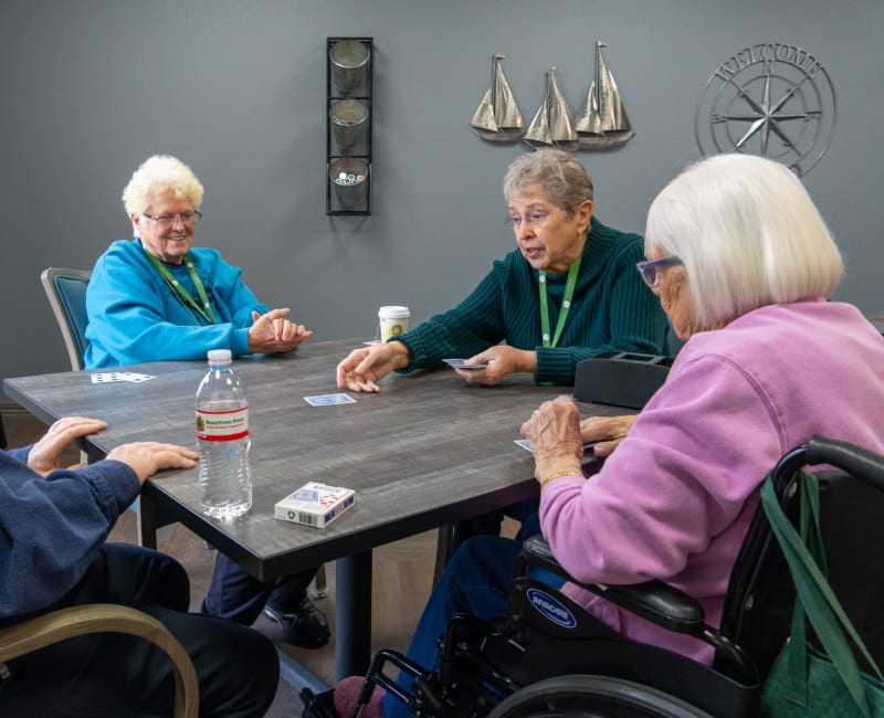  Group of senior residents playing a tabletop game at The Sycamore of River Falls in River Falls, Wisconsin