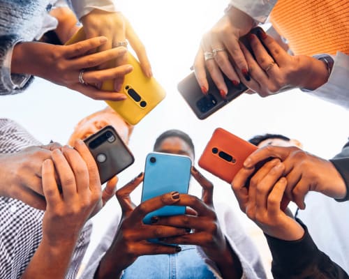 Residents look at their phones at University Lofts at Russellville, Russellville, Arkansas
