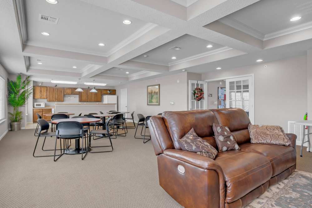 Clubhouse with large couch and view to kitchen at River Ridge in Sand Springs, Oklahoma
