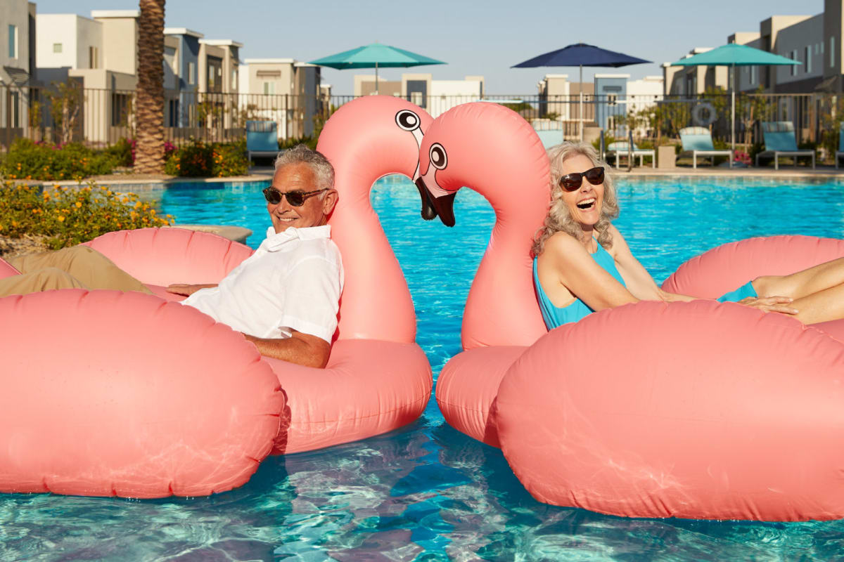 Two residents floating in the pool at BB Living at Civic Square in Goodyear, Arizona