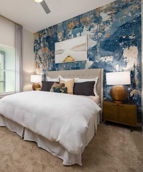Bedroom with plush carpet at The Edison Sugarloaf in Lawrenceville, Georgia