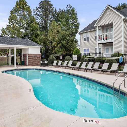 Pool with lounge chairs at Brittany Place Hendersonville in Henderson, North Carolina
