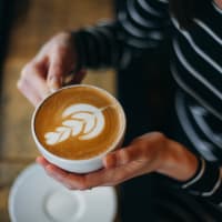 Person drinking a latte at Encore Townhomes in Utica, Michigan