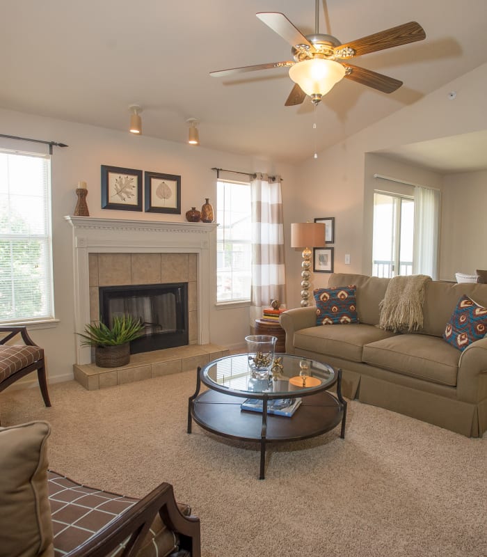 Carpeted living room at Villas at Stonebridge in Edmond, Oklahoma