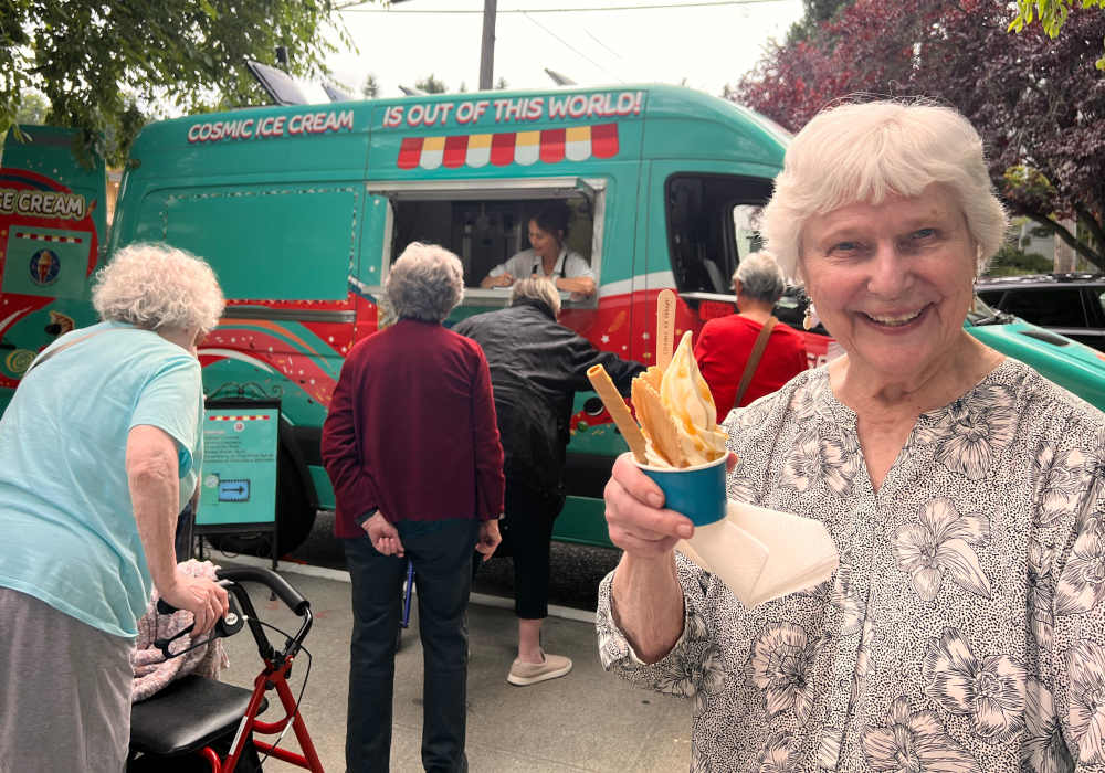 Residents waiting in line for ice cream from an ice cream truck at Merrill Gardens at The University in Seattle, Washington