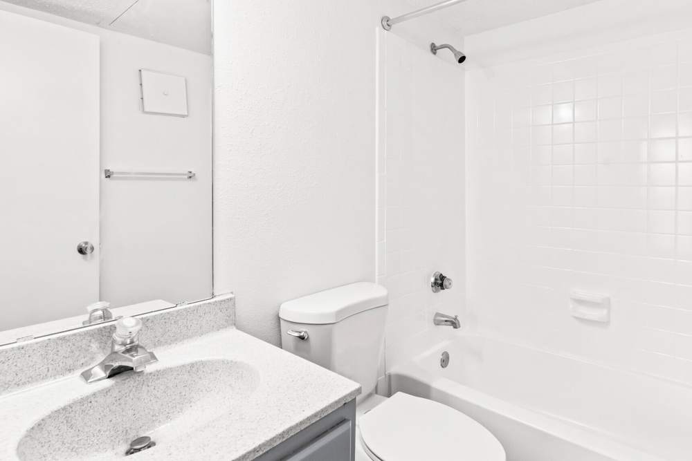 Bright bathroom with bathtub at Plantation West in Hurst, Texas