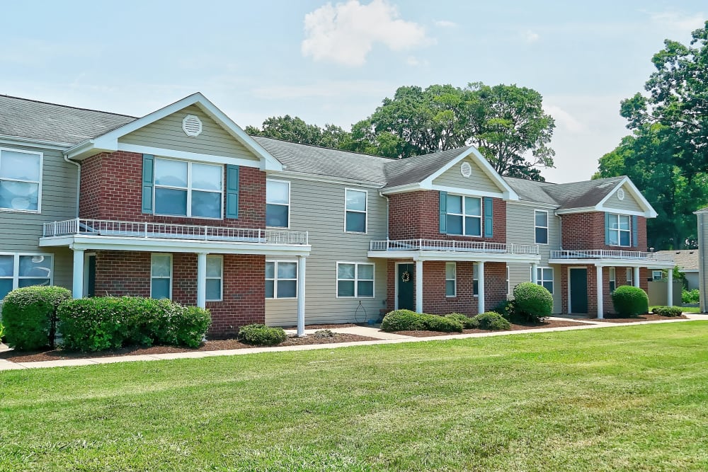 Backside view of townhomes with lots of grass as Mariner's Watch in Norfolk, Virginia