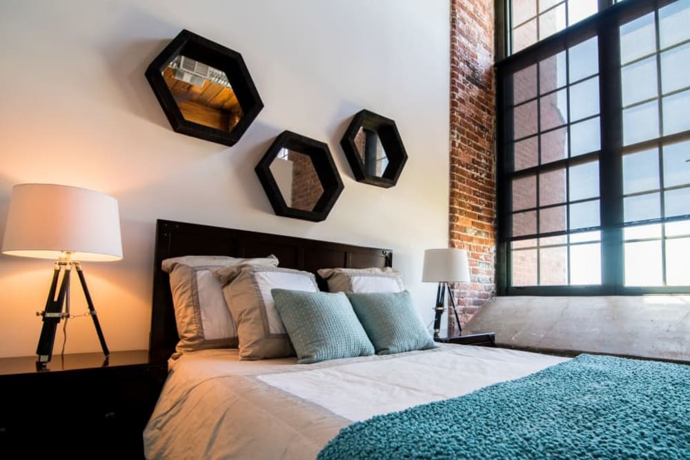 Stylish living space with large windows at Loray Mill Lofts in Gastonia, North Carolina