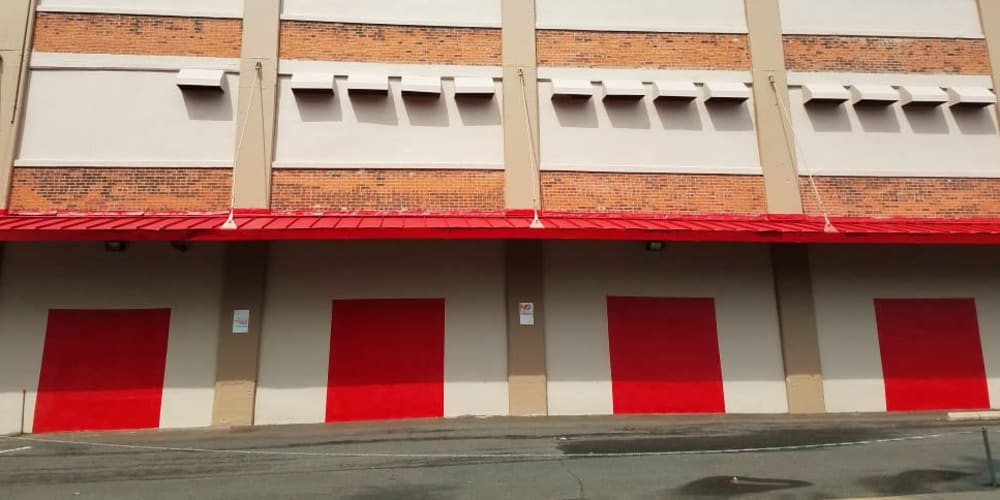 Exterior units with red doors at StorQuest Self Storage in New Haven, Connecticut